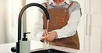 Washing hands, home and woman in kitchen, hygiene and cleaning with faucet, remove bacteria and water. Apartment, safety and elderly person with tap, wellness or germ prevention with liquid or splash