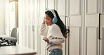 Girl, child and dancing with headphones in kitchen, rhythm and smile with streaming subscription in home. Kid, happy and listen to music with audio tech, song and dancer with sound at apartment