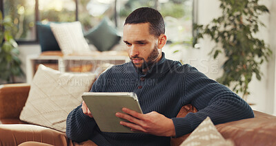 Buy stock photo Reading, research and tablet with man on sofa in living room of home for social media review or travel. Accommodation, app and online booking with person in apartment for holiday or vacation planning