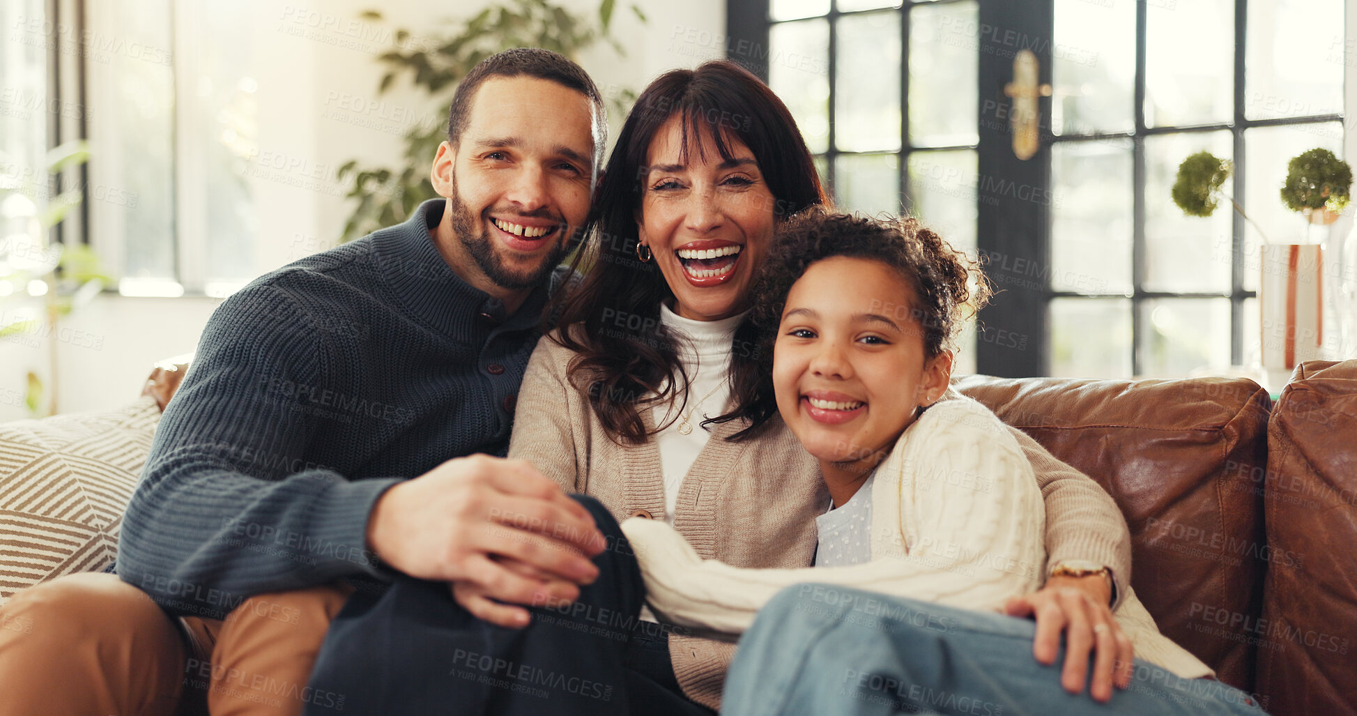 Buy stock photo Parents, girl and hug on sofa for portrait, happy and bonding with love in living room at family house. People, mother and daughter with father, smile and embrace with care on couch at apartment