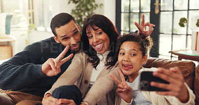 Buy stock photo Parents, girl and selfie on sofa with funny face, smile and peace sign for memory in living room. People, photography and happy for profile picture, v symbol and post on social media at family home