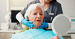 Dental, senior woman and mirror with results for teeth whitening, gum disease and dentures. Pensioner, healthcare and dentist with elderly patient in clinic for cavity removal or root canal treatment