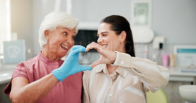 Buy stock photo Woman, dentist and heart hands at clinic, smile and gratitude with good service for oral care. Mature person, orthodontist and patient with love emoji, sign or happy with dental health at hospital