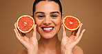 Happy, woman and grapefruit with portrait for beauty, natural skincare and facial glow. Smile, person and fruit for collagen, vitamin c and organic ingredients of treatment shine in studio background