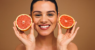 Buy stock photo Happy, woman and grapefruit with portrait for beauty, natural skincare and facial glow. Smile, person and fruit for collagen, vitamin c and organic ingredients of treatment shine in studio background