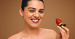 Girl, portrait and beauty with strawberry in studio, results and natural makeup with glow on background. Woman, happy and fruit with dermatology, confidence and pride for cosmetics in Australia
