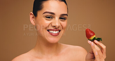 Buy stock photo Girl, portrait and beauty with strawberry in studio, results and natural makeup with glow on brown background. Woman, happy and fruit with dermatology, confidence and pride for cosmetics in Australia