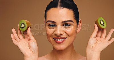 Buy stock photo Beauty, kiwi and portrait of woman in studio for vitamin c, skincare and antioxidants glow. Self care, organic dermatology and natural enzyme facial with person and fruit on brown background