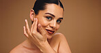 Cosmetology, beauty portrait and girl in studio with natural makeup, cosmetics and lipstick. Mockup space, happy woman and touch face on brown background for foundation coverage, healthy glow or skin