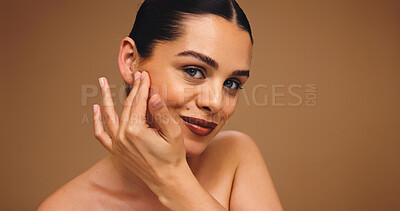 Buy stock photo Cosmetology, beauty portrait and girl in studio with natural makeup, cosmetics and lipstick. Mockup space, happy woman and touch face on brown background for foundation coverage, healthy glow or skin