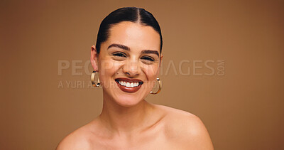 Buy stock photo Makeup, earrings and happy woman in studio for aesthetic, glow and shine on brown background space. Beauty, ear jewelry and model with lipstick cosmetics, face transformation and portrait with change