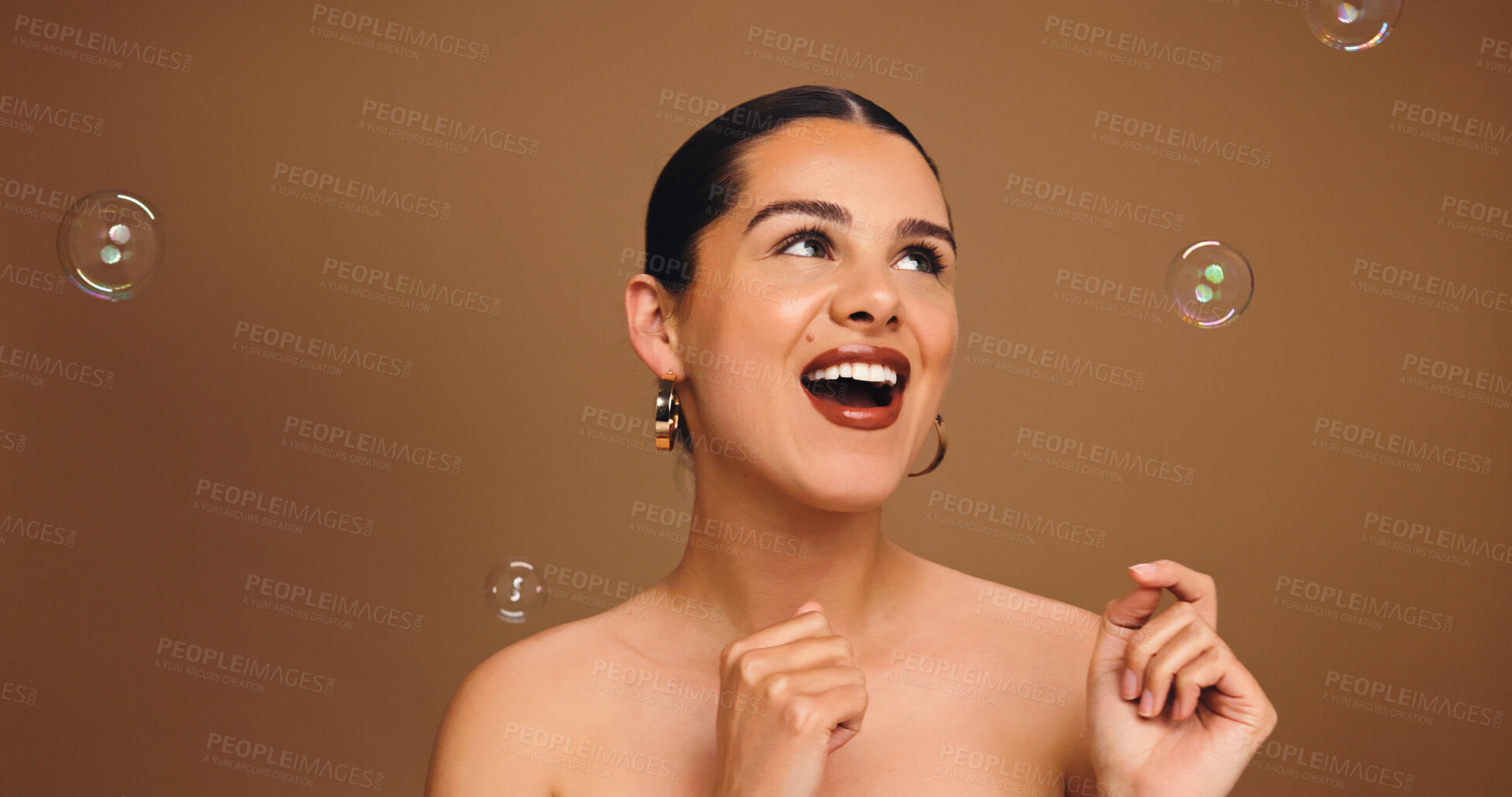 Buy stock photo Bubbles, happy and woman in studio for skincare, beauty and cosmetics for wellness, health and glow. Thinking, space and person with soap for spa aesthetic, makeup and dermatology on brown background