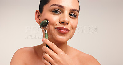 Buy stock photo Happy woman, portrait or beauty with jade roller in studio for facial massage on a white background. Female person, model or skincare tool for face, lymphatic drainage or health and wellness on space