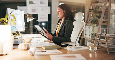 Buy stock photo Online, employee and woman with tablet in office, document or financial analysis on website at night. Serious, accountant and person with computer for investment opportunity, graphs and working late