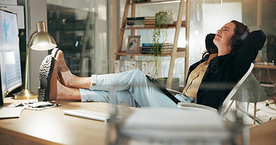 Buy stock photo Business, night and woman in office, relax and completed assignment with headphones. Person, evening and employee in workplace, resting and listening to music, finished task and sound with audio