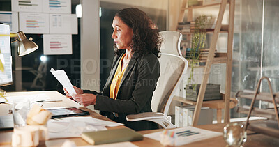 Buy stock photo Computer, finance and paper with business woman in office at night for review of information. Data, documents and reading with corporate employee in financial workplace for evening administration