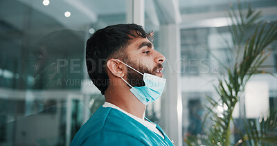 Buy stock photo Man, surgeon and sad in lobby with thinking, fatigue and stress with grief for lost patient at hospital. Person, doctor and depression by window with reflection, memory or burnout with job at clinic