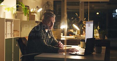 Buy stock photo Man, reading and laptop at night in office with review, work article and deadline. Mature person, overtime and computer for research, feedback and thinking for draft task in publishing company