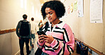 Student, girl and phone in hallway at high school for text message, social media or online portal for assessment. Female person, teenager and mobile app for academic communication or email on campus