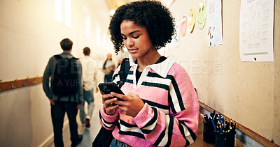 Buy stock photo Student, girl and phone in hallway at high school for text message, social media or online portal for assessment. Female person, teenager and mobile app for academic communication or email on campus