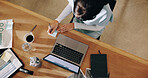 Business woman, writing and sticky note with laptop above for schedule planning or task in office. Top view, female person or planner with computer or documents for reminder, agenda or idea on desk