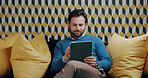 Businessman, creative and research with tablet on sofa for web design, online report or analysis. Man, employee or digital designer with technology on couch for company creativity in lounge suite