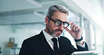 Glasses, mature or businessman in office with tablet, reading email or review of finance report. Corporate, research or person in company with technology, planning or evaluation for financial audit