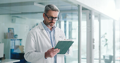 Buy stock photo Reading, tablet and glasses with doctor in hospital for healthcare report, research grant and planning. Medical case review, clinical guidelines and telehealth app with mature person for insurance