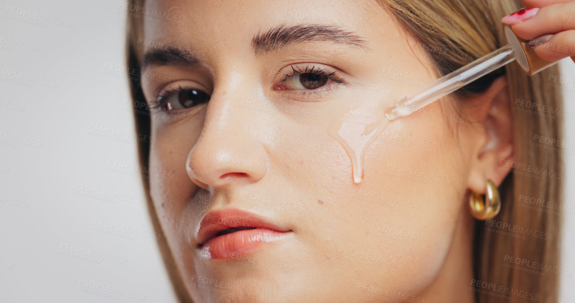 Buy stock photo Beauty, skincare and girl with serum in studio for hydration, hyaluronic acid or anti aging benefits. Dropper, person and apply retinol product on white background for skin elasticity or glowing face
