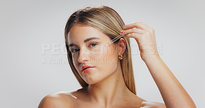 Buy stock photo Beauty, portrait and woman with serum in studio for hydration, hyaluronic acid or skin benefits. Dropper, person or apply retinol product on white background for face elasticity, glow or mockup space