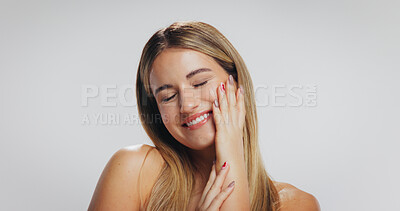 Buy stock photo Beauty, girl and happy with skincare in studio for acne treatment results, healthy glow or self care. Mockup space, person and touching face on white background with skin wellness and natural makeup