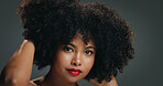 Hair, makeup and portrait of woman in studio for afro volume, beauty or cosmetic treatment. Aesthetic, growth and shampoo with serious African model isolated on gray background for haircare results