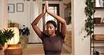 Black woman, yoga and namaste hands in living room for mind body connection, meditation and relax. Mental clarity, posture benefits and person in home for spiritual practice, zen and morning routine.