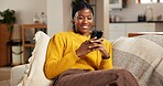 Black woman, mobile and relax on sofa with social media, text message and reading online blog. Person, phone and smile in home living room for funny email, meme website and chill with chat platform