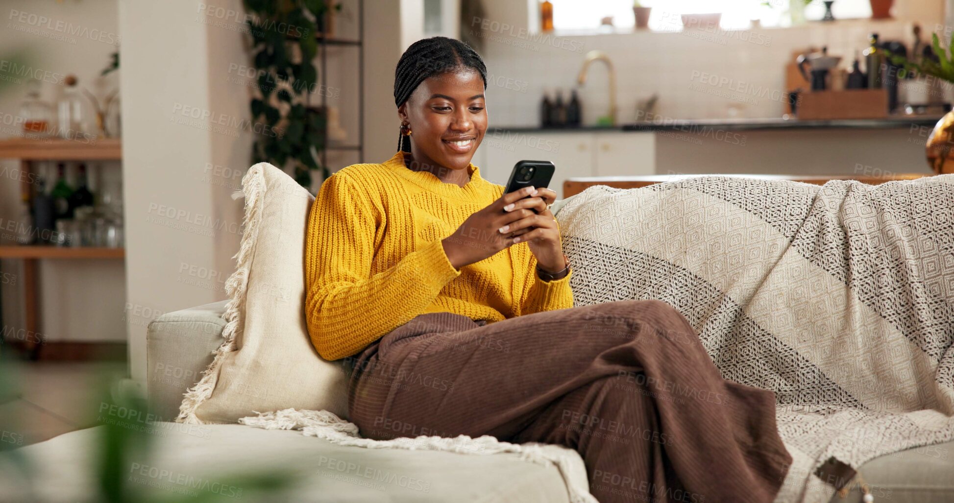 Buy stock photo Black woman, phone and relax on sofa with social media, text message and reading online blog. Person, mobile and smile in home living room for funny email, meme website and chill with chat platform