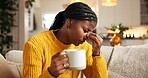 Black woman, headache and mug with stress on sofa for mental health, pressure or eye strain in home. Tired, female person or migraine with pain, cup or fatigue for mistake, fail or fever in house