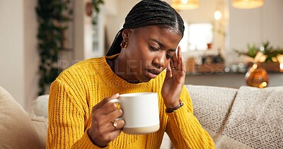 Buy stock photo Stress, woman and coffee with headache on sofa from burnout, mental health or brain fog. Vertigo, beverage and black person with tension migraine in home with discomfort, uncomfortable ache and dizzy