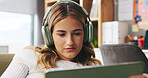 Woman, relax and headphones with tablet at house for streaming, social media and listening to music. Female person, digital and browsing for movie search, film audio and playlist sound in living room
