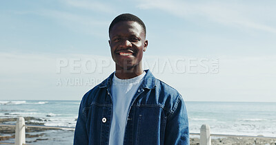 Buy stock photo Happy, portrait and black man at beach for travel, sightseeing and weekend getaway in summer. Confident, smile and person outdoor on promenade with space, vacation and holiday break for wellness.