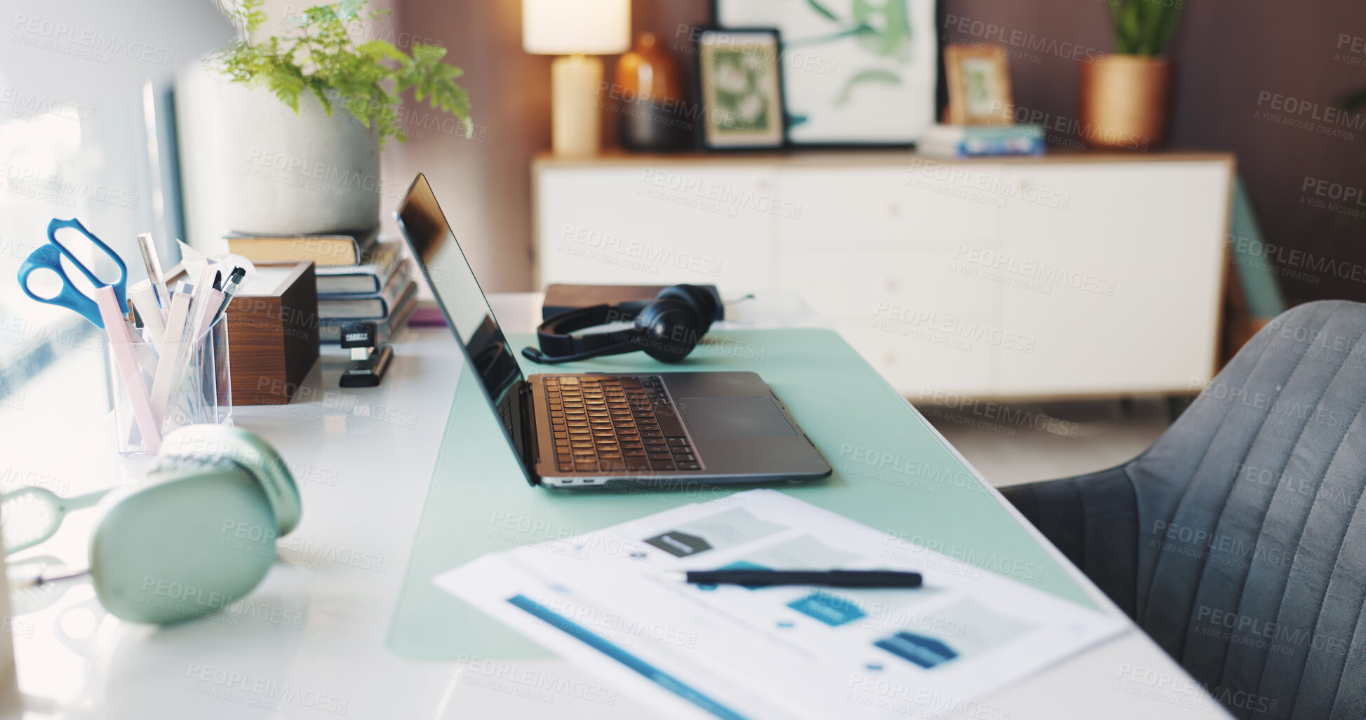 Buy stock photo Documents, headphones and laptop on desk in home office for planning, remote work or research. Computer, creative workstation and paperwork in empty apartment for freelance or small business startup