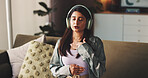 Breathing, headphones and wellness with woman on sofa in living room of home for audio therapy. Relax, white noise and zen with person listening to sound in apartment for awareness or mindfulness