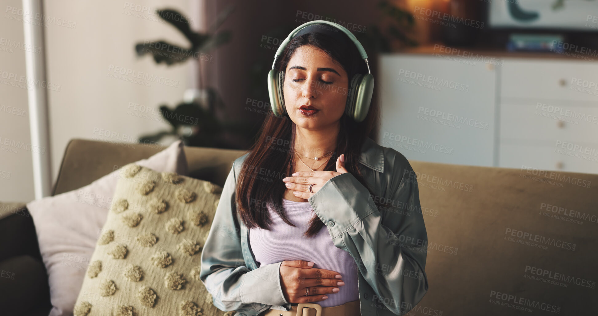 Buy stock photo Breathing, headphones and wellness with woman on sofa in living room of home for audio therapy. Relax, white noise and zen with person listening to sound in apartment for awareness or mindfulness