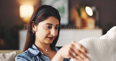 Buy stock photo Smile, laundry and cleaning with woman on sofa for clothes maintenance, fabric check and hygiene. Fresh linen, sanitary and packing with female person in living room of home for domestic chores