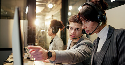 Buy stock photo Computer, team and people in call centre with pointing, lens flare or assistance at night. Coworking, collaboration and telemarketer at tech for overtime, colleague support or guidance in sales.