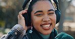 Happy, portrait and woman in nature with headphones, streaming music and podcast for wellness. Smile, listening and female person outdoor in park with wireless technology, audio and online radio