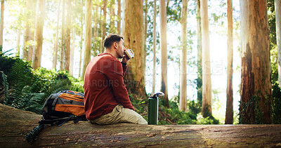 Buy stock photo Coffee, hiking and thinking with man in forest for hobby, trekking or thirst as tourist for journey. Adventure, beverage and break with hiker person outdoor in nature for discovery or sightseeing