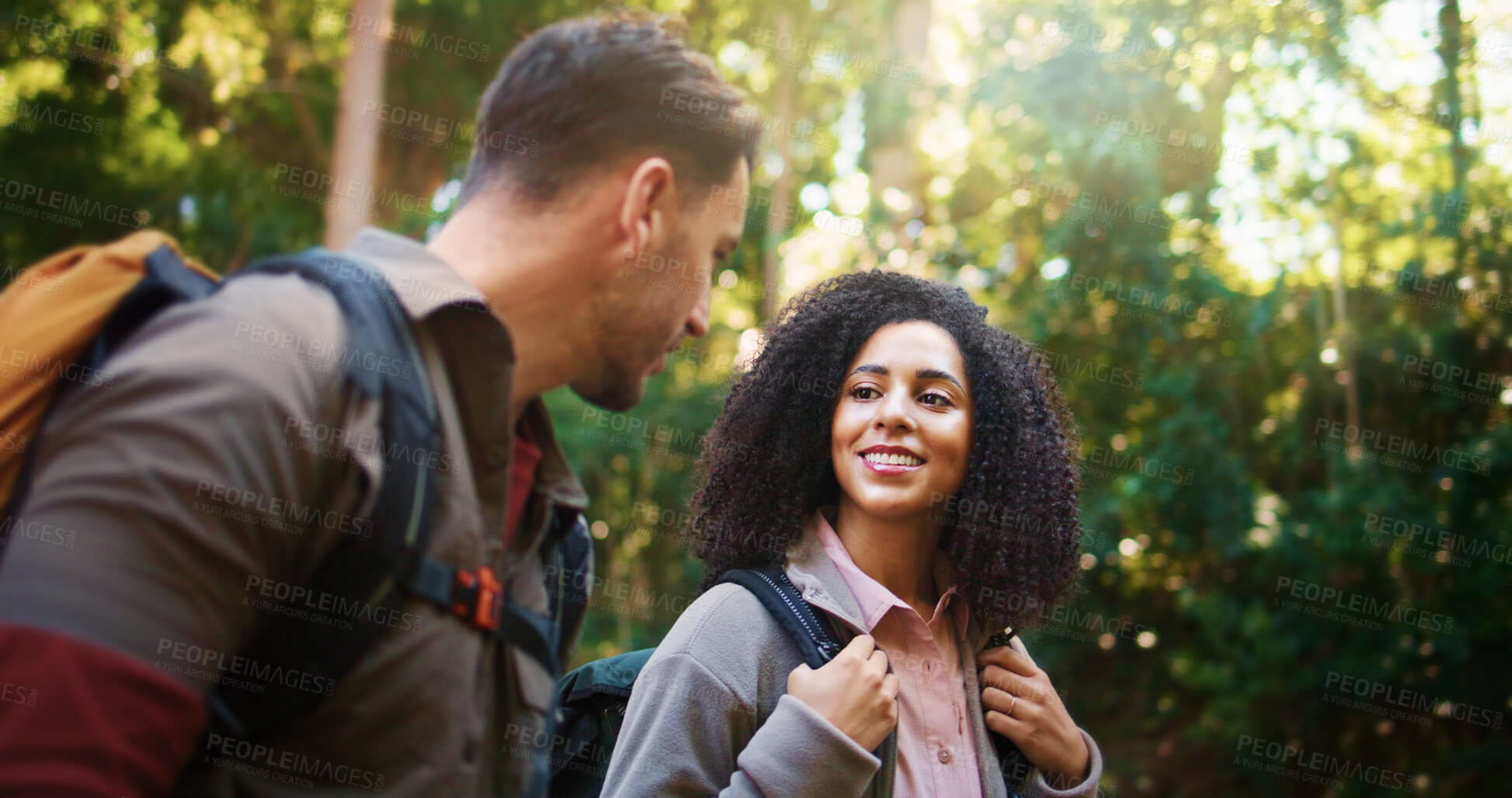 Buy stock photo Hiking, walking and smile with couple in nature for holiday, trekking adventure and bonding. Backpacking date, environment and vacation with man and woman in forest for love, support and hobby