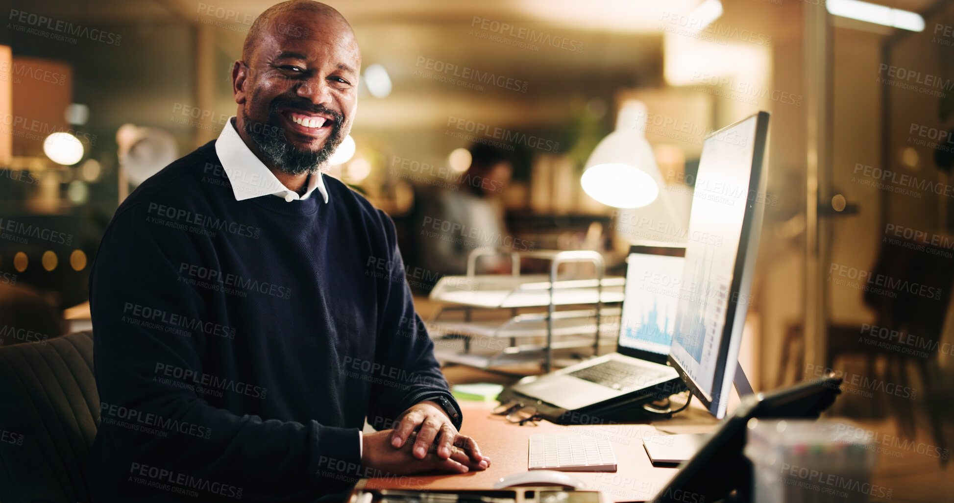 Buy stock photo Computer, finance and portrait of business black man in office at night for risk management. Portfolio, review and smile of mature employee reading financial charts, data or graphs at work in evening
