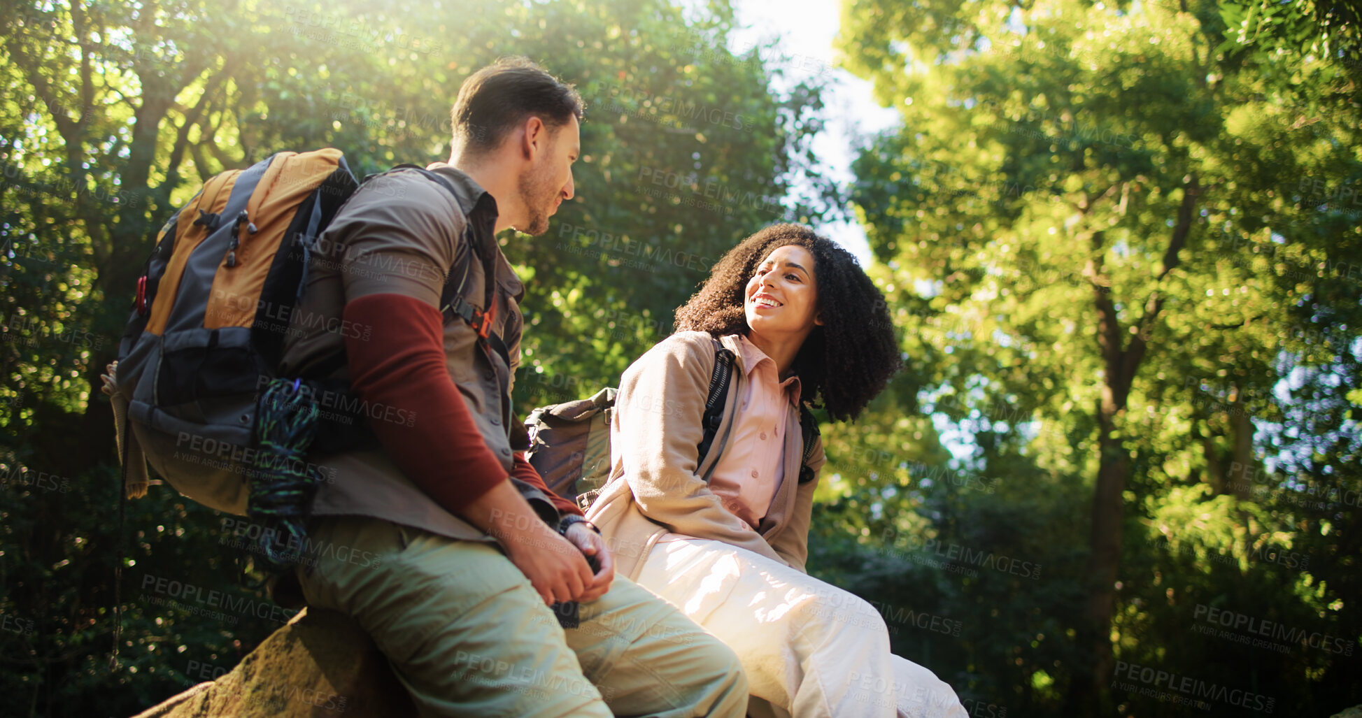 Buy stock photo Hikers, talk and couple in nature, relax and break on adventure, forest and love on holiday or trip. Outdoor, people and bonding on journey, backpacking or happy on vacation, low angle and woods