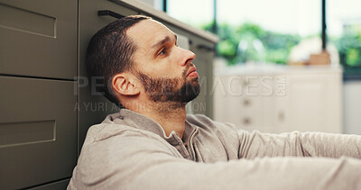 Buy stock photo Sad, thinking and man in kitchen with stress, mental health challenge or worry for debt. Depression, reflection and person in home with anxiety for financial crisis, bankruptcy and regret mistake